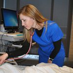 Nursing student using stethoscope